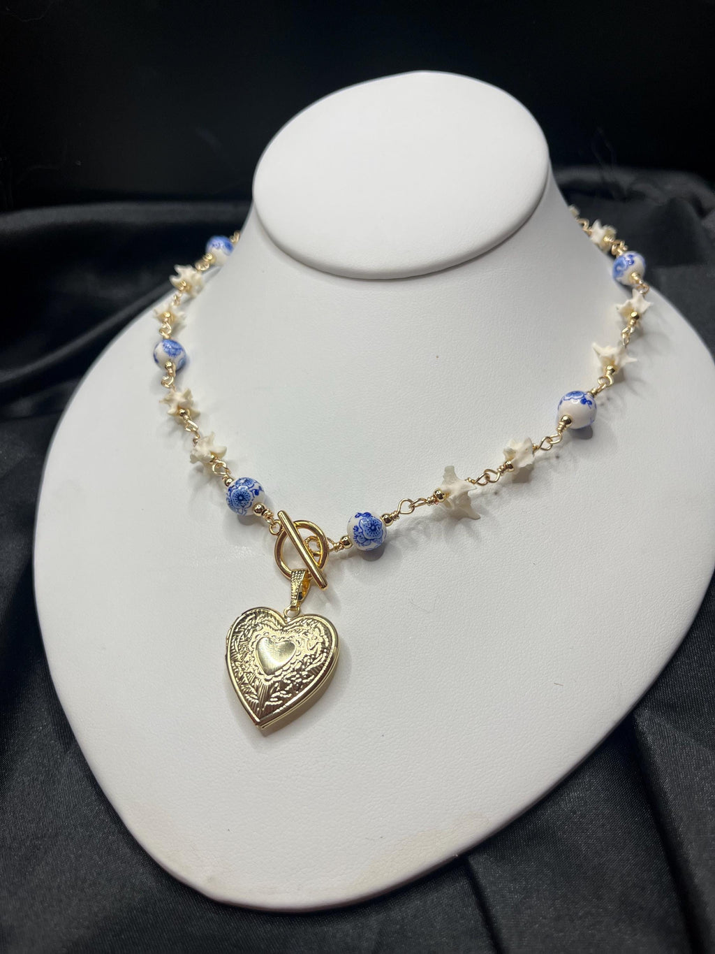 Rattlesnake Vertebrae Necklace with Blue Floral Ceramic Beads and Gold Plated Heart Locket | Toggle Closure – 16.5”