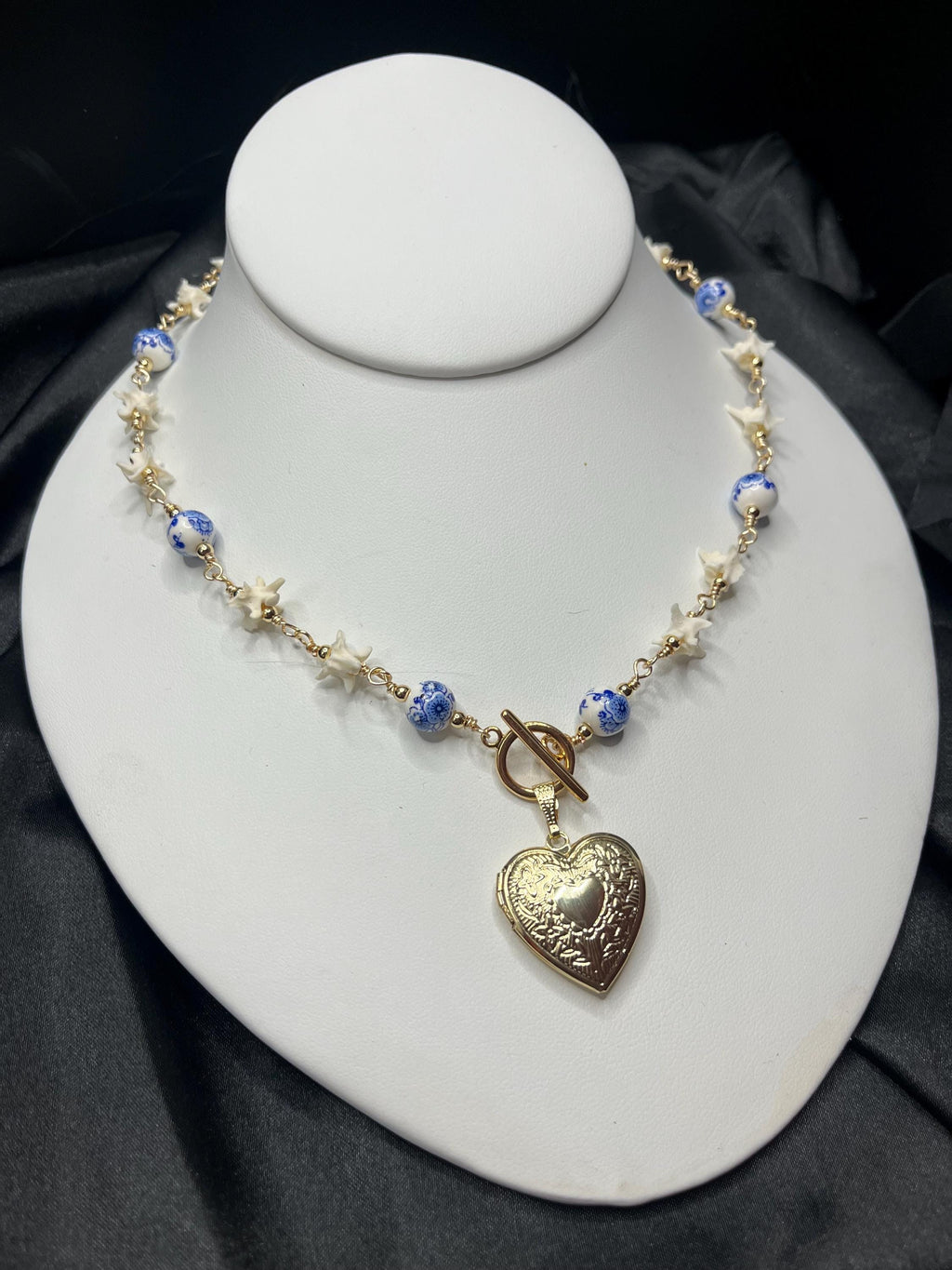 Rattlesnake Vertebrae Necklace with Blue Floral Ceramic Beads and Gold Plated Heart Locket | Toggle Closure – 16.5”