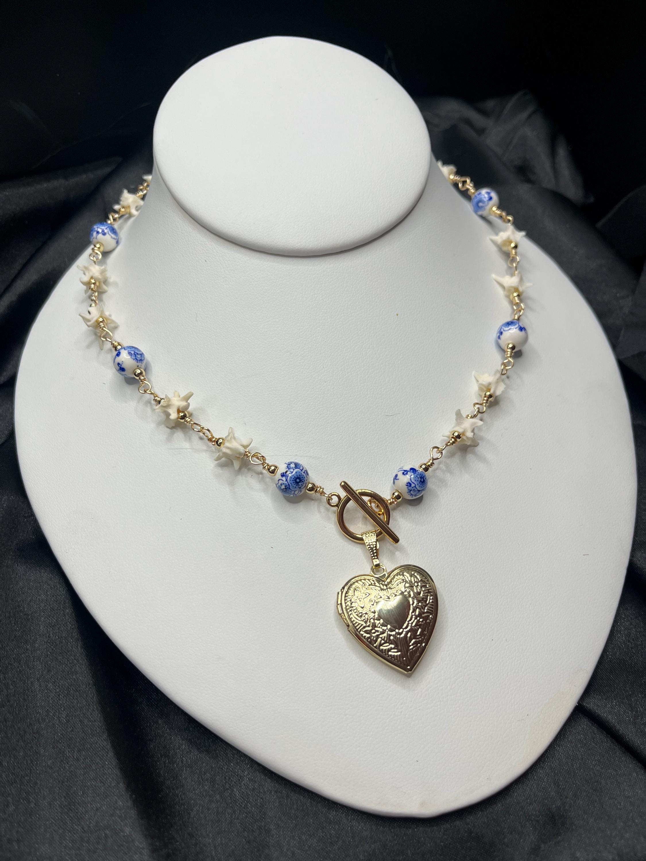 Rattlesnake Vertebrae Necklace with Blue Floral Ceramic Beads and Gold Plated Heart Locket | Toggle Closure – 16.5”