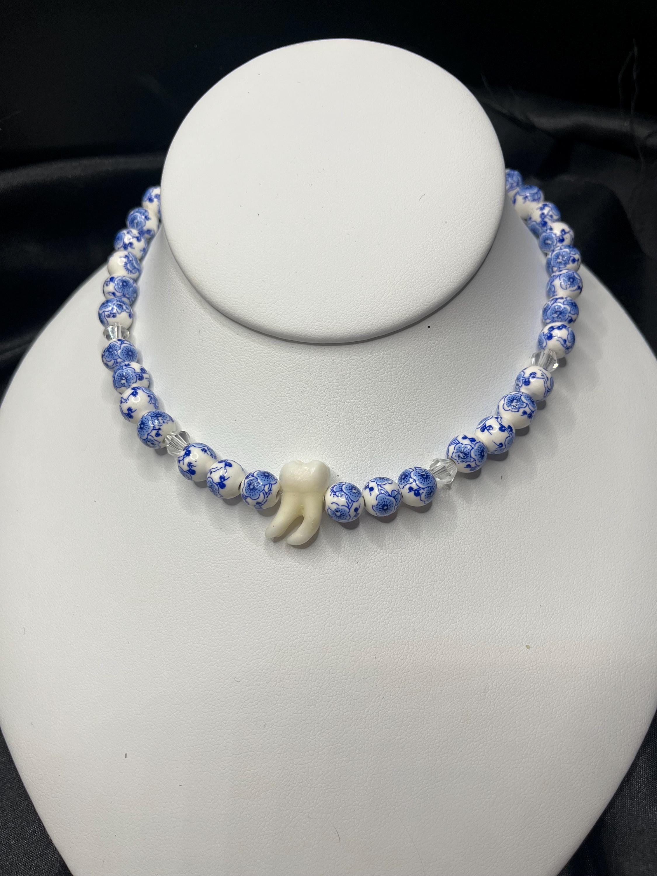 Human Tooth Necklace with Blue and White Floral Ceramic Beads and Crystal Accents, Stainless Steel, 14–16”