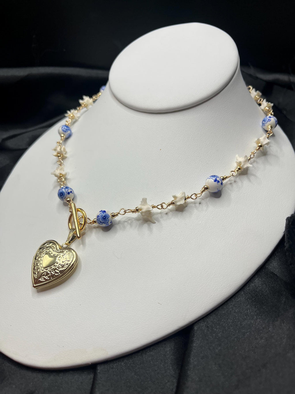 Rattlesnake Vertebrae Necklace with Blue Floral Ceramic Beads and Gold Plated Heart Locket | Toggle Closure – 16.5”