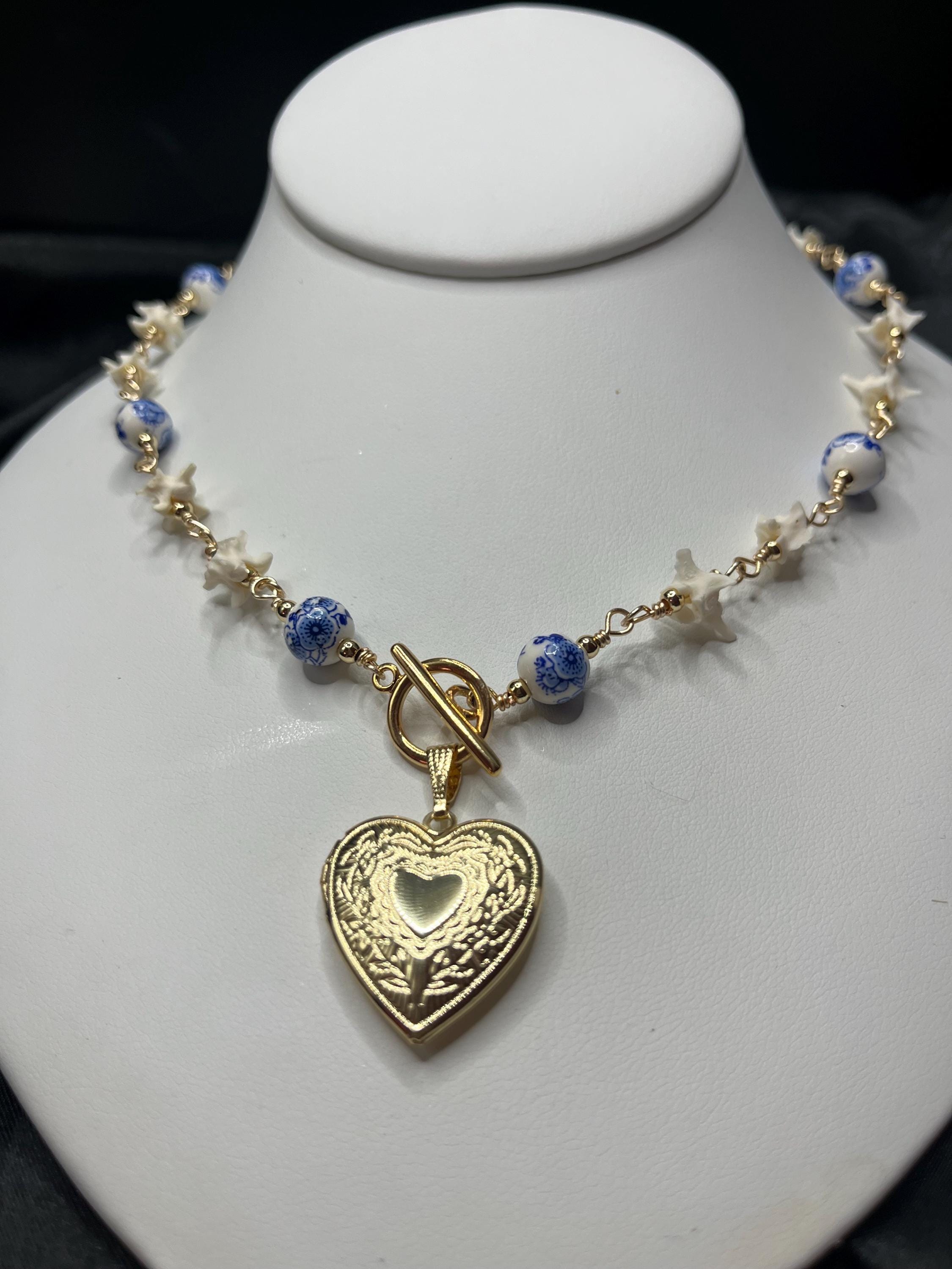 Rattlesnake Vertebrae Necklace with Blue Floral Ceramic Beads and Gold Plated Heart Locket | Toggle Closure – 16.5”