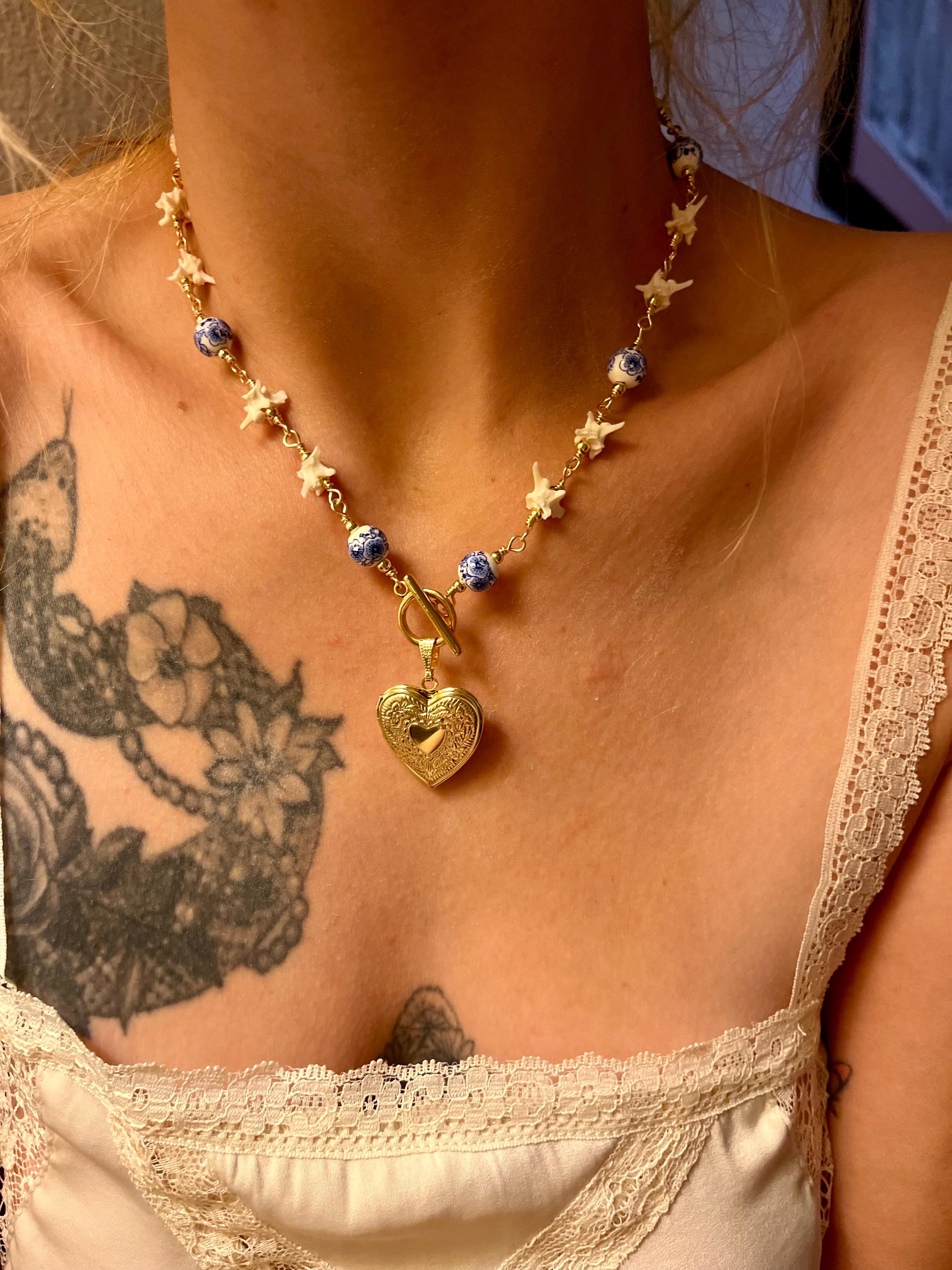 Rattlesnake Vertebrae Necklace with Blue Floral Ceramic Beads and Gold Plated Heart Locket | Toggle Closure – 16.5”