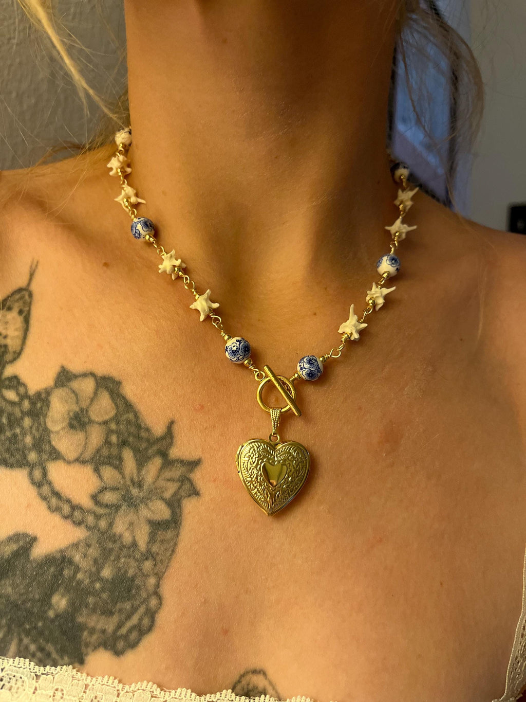 Rattlesnake Vertebrae Necklace with Blue Floral Ceramic Beads and Gold Plated Heart Locket | Toggle Closure – 16.5”