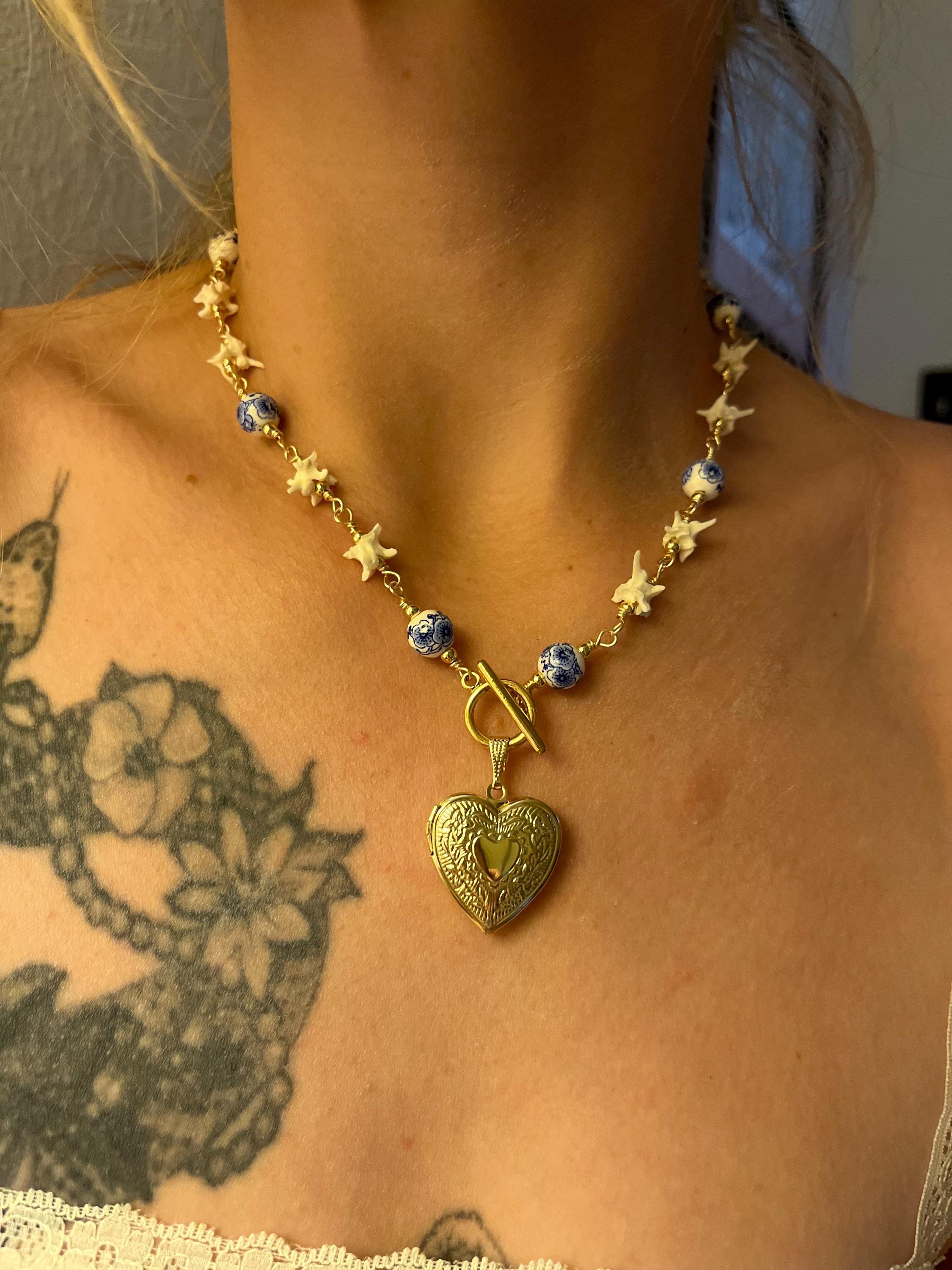 Rattlesnake Vertebrae Necklace with Blue Floral Ceramic Beads and Gold Plated Heart Locket | Toggle Closure – 16.5”
